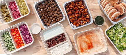 our catering build a bar.  showing mains, bases, toppings and sauces laid out and everyone can create their own meal.